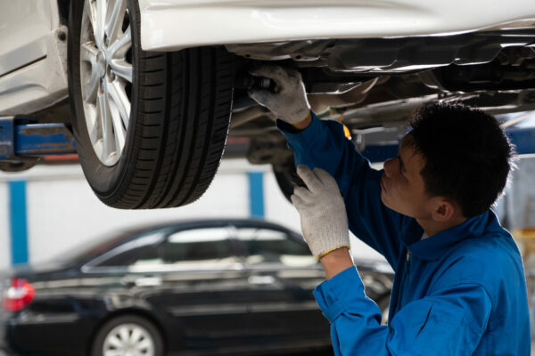 Mechanic,Fixing,Car,Suspension,With,Car,Lifting.,Mechanic,Checking,Tire