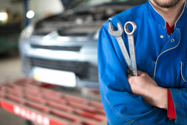 Hand,Of,Car,Mechanic,With,Wrench.,Auto,Repair,Garage.